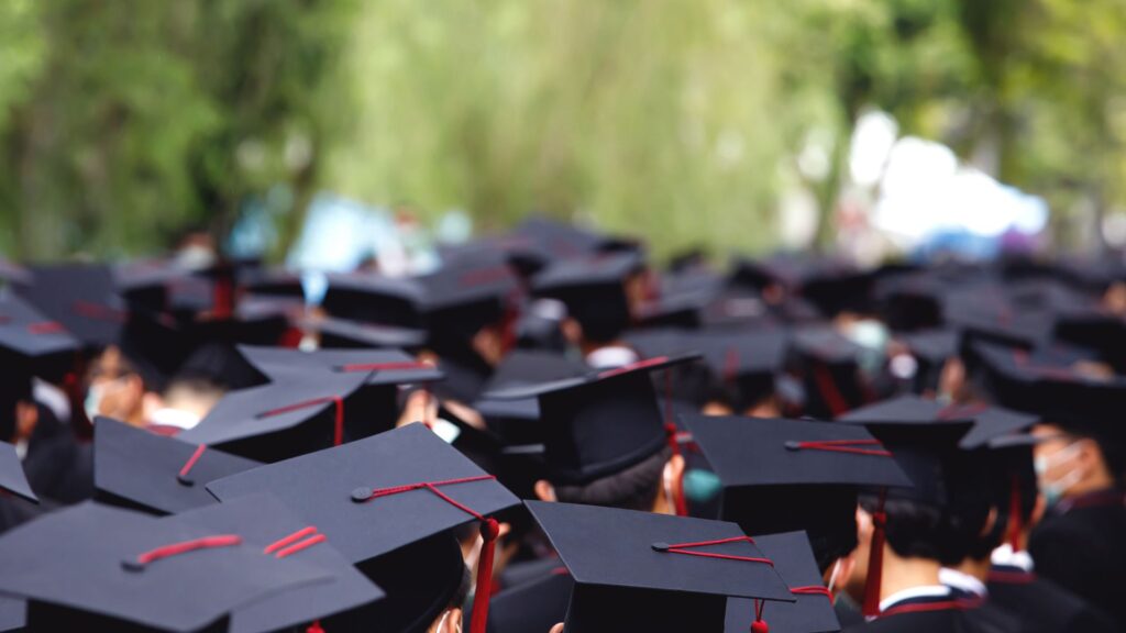 students wearing black graduation caps