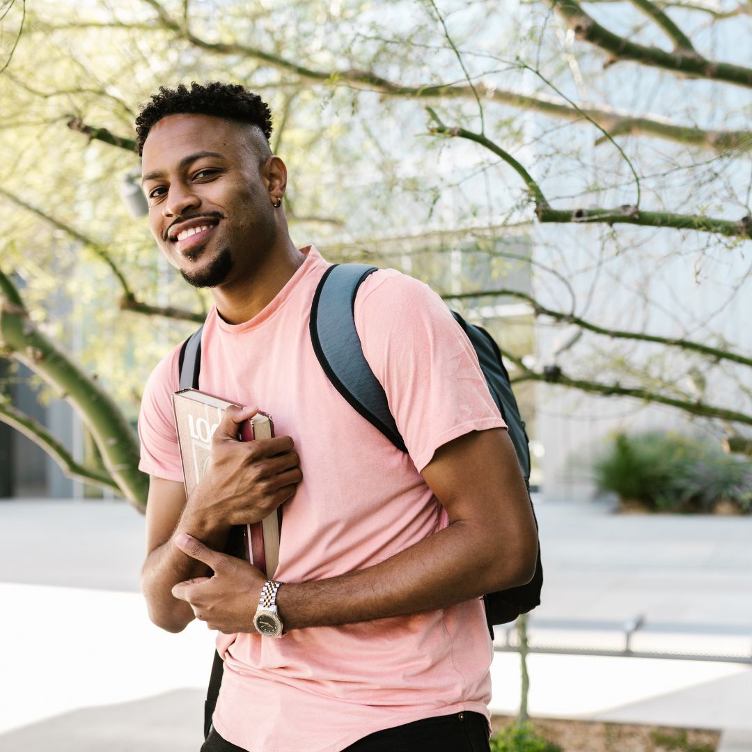 a young man walking to class